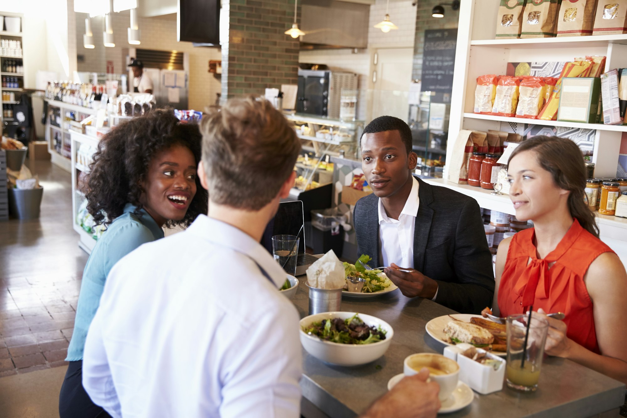 Group Enjoying Business Lunch In Delicatessen