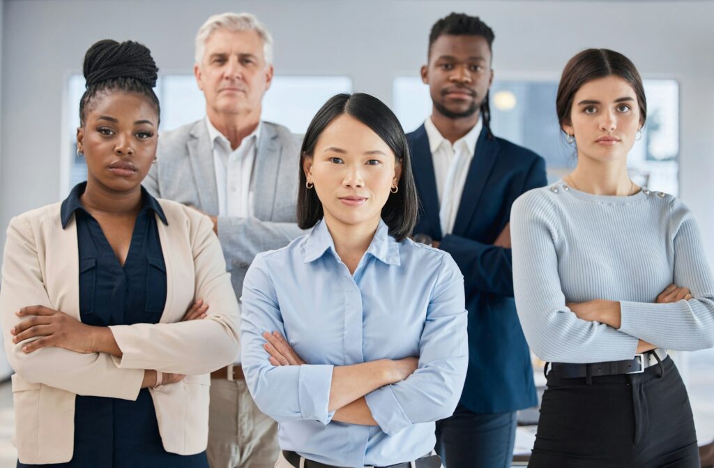 Portrait, arms crossed and leadership of Asian woman with business people in office for company goa